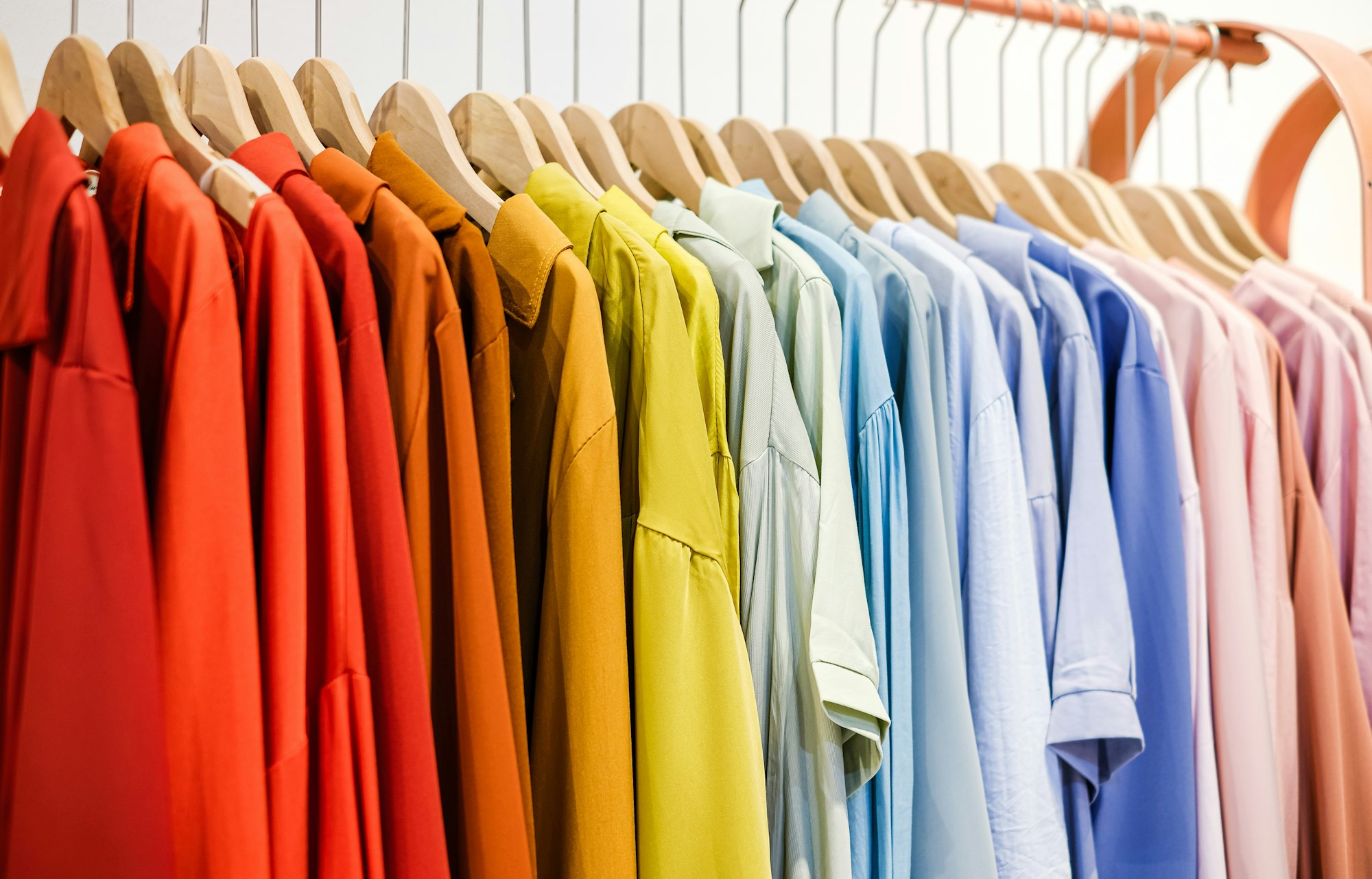 Fashionable clothes on a hanger. close - up of clothes in the store rainbow color.